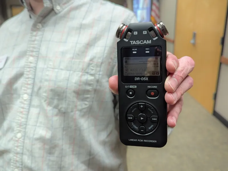 Patron holding oral kit recording device