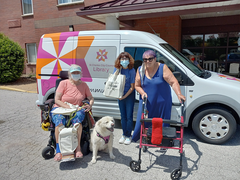 Outreach services visitng a senior center delivering materials to residents