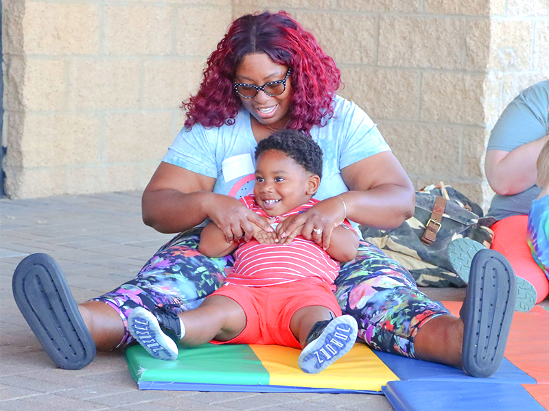 Mom and son enjoying a story time outside the library