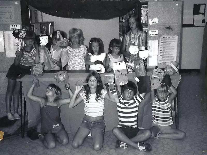 black and white image of a kids story time and hand-made puppets