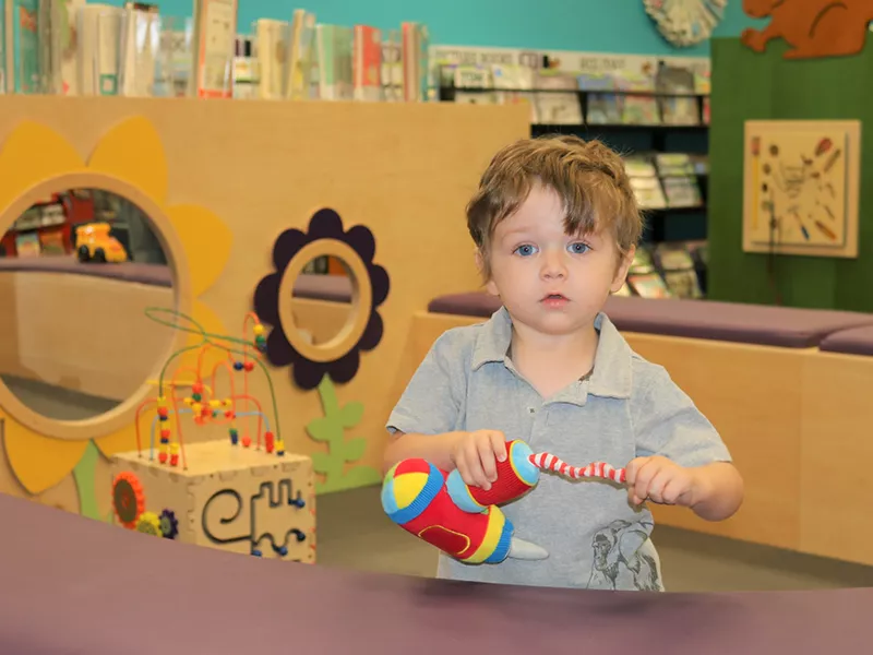 young child in library play area