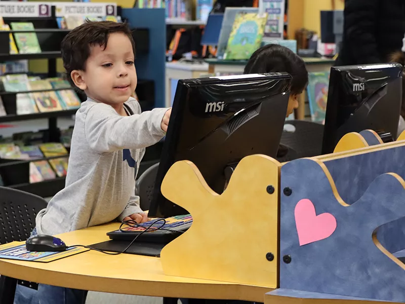 Young child using early literacy computer