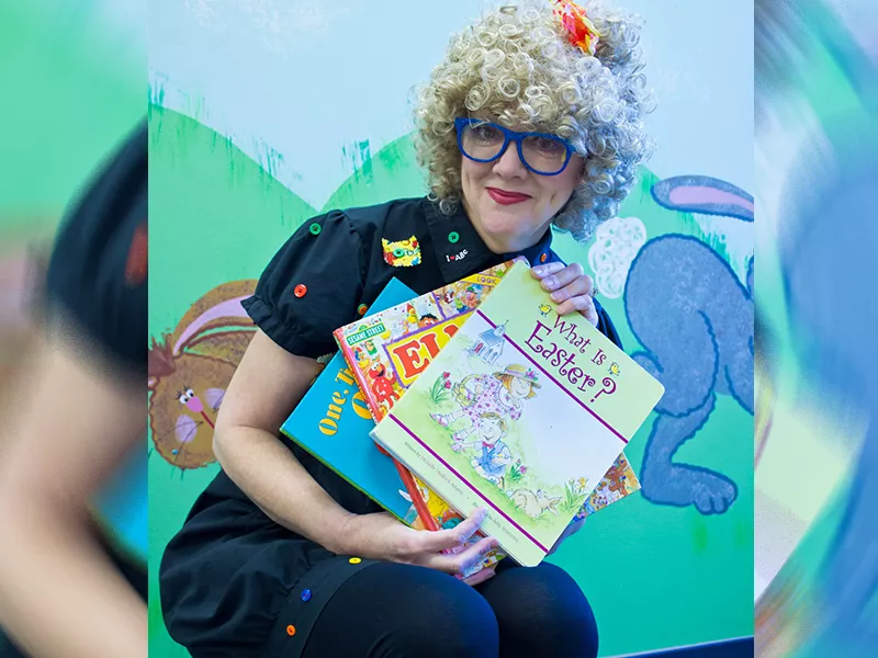 Reading Rita holding a couple of children's books