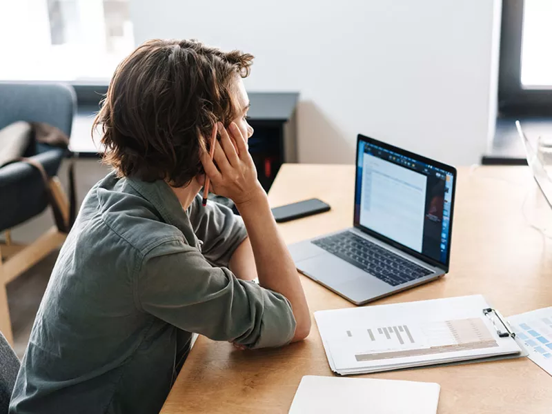 young person looking at a laptop screen