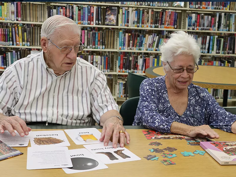 two older adults using the stay sharp kits from the Library of Things collection