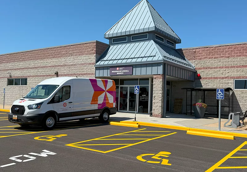 Exterior photo of Middendorf-Kredell Branch with a library van parked in front
