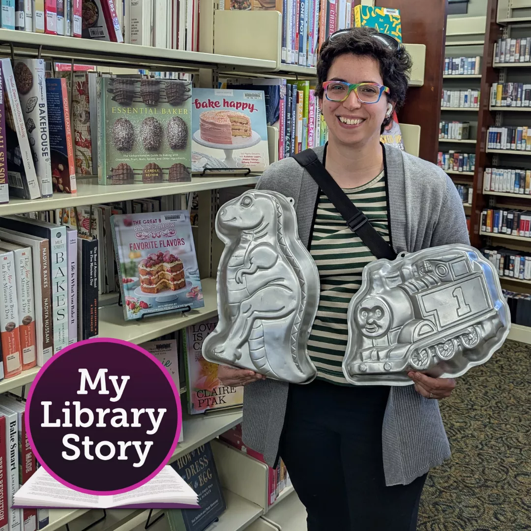 Library patron Kat holding two character cake pans