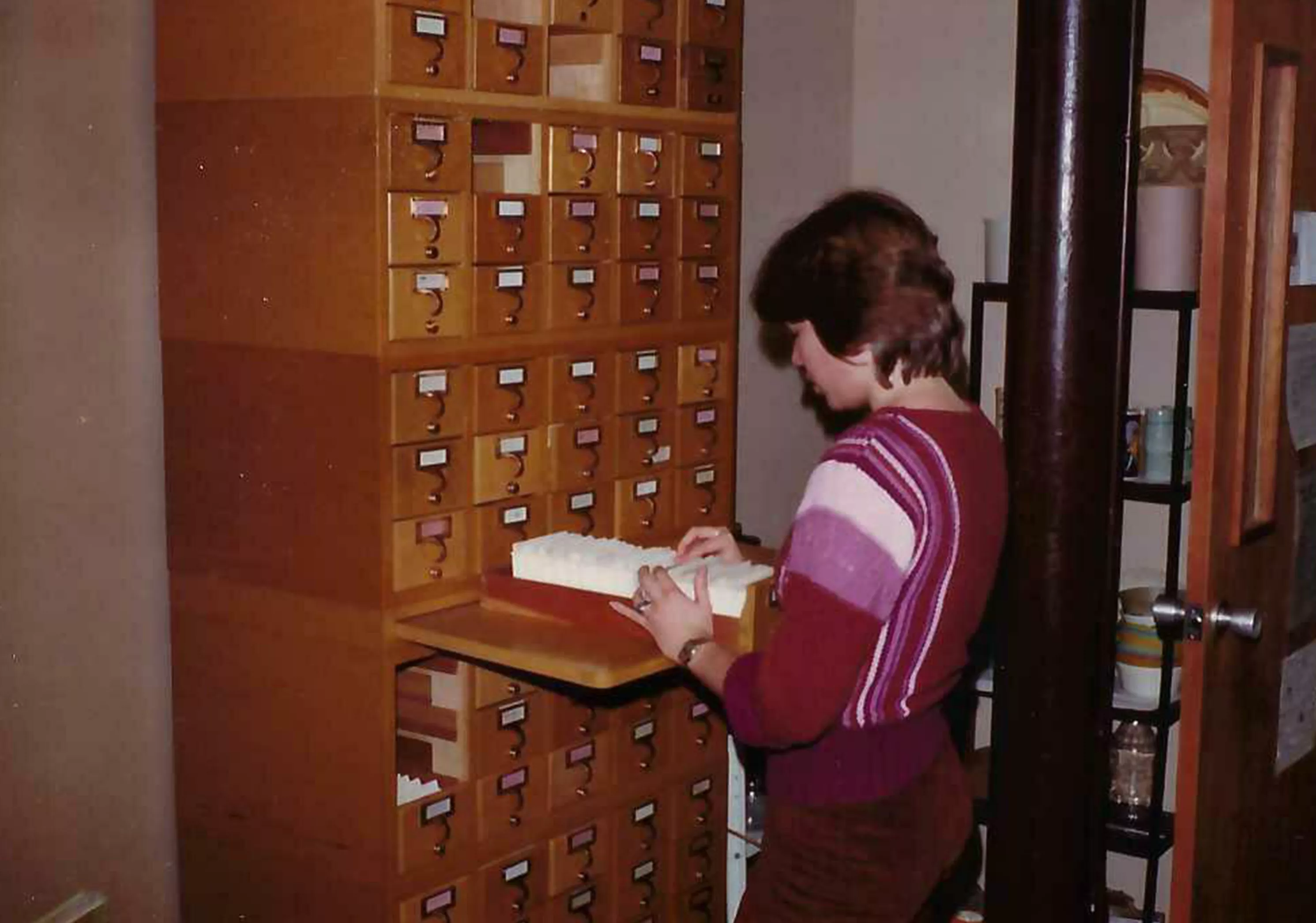 colored image of person using the card catalog